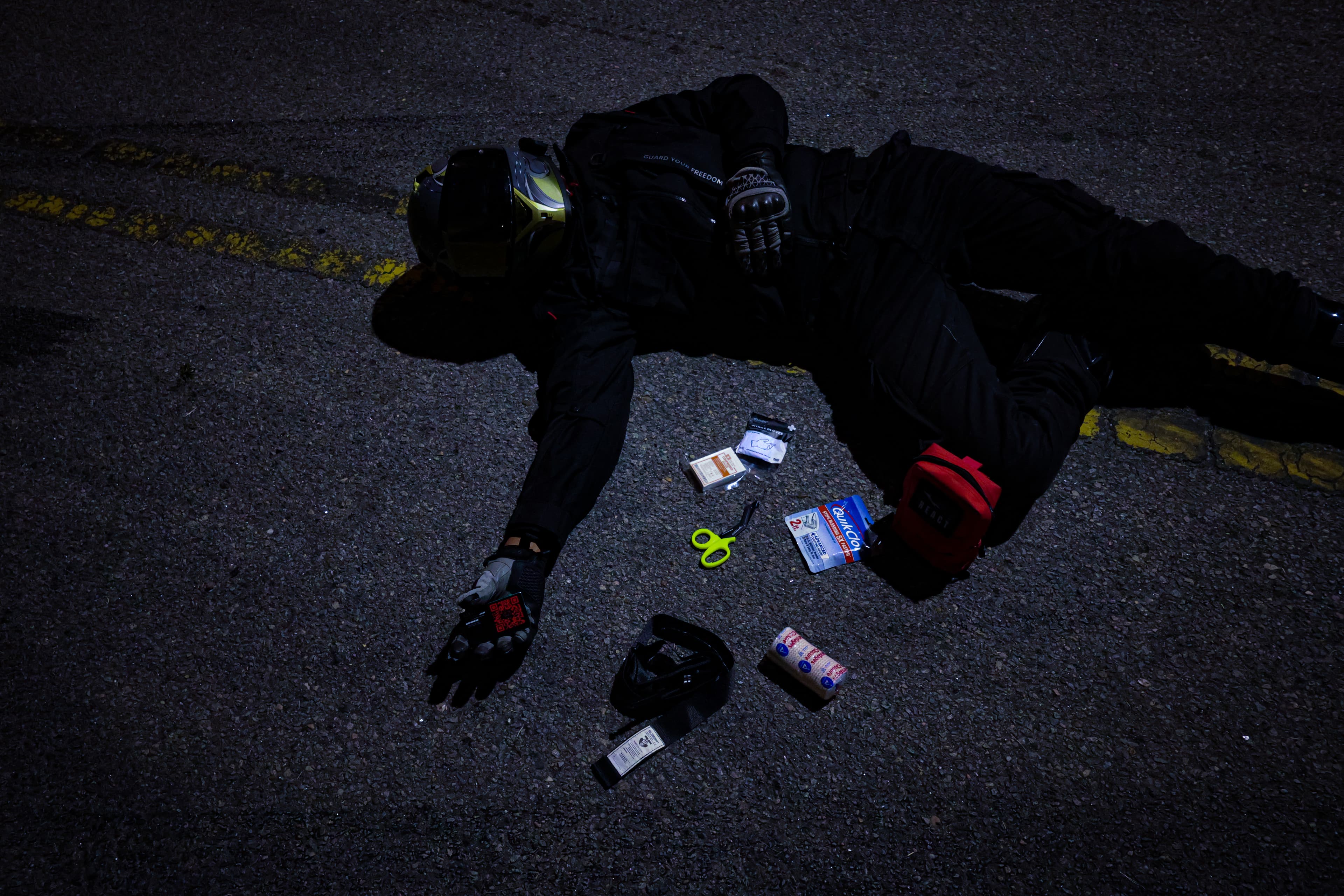R.E.A.C.T. trauma kit contents laid out next to a rider during a simulated response